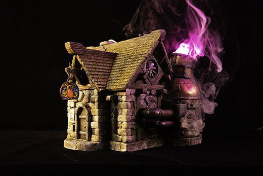 A miniature fantasy alchemy shop with arcane smoke billowing out its chimney
